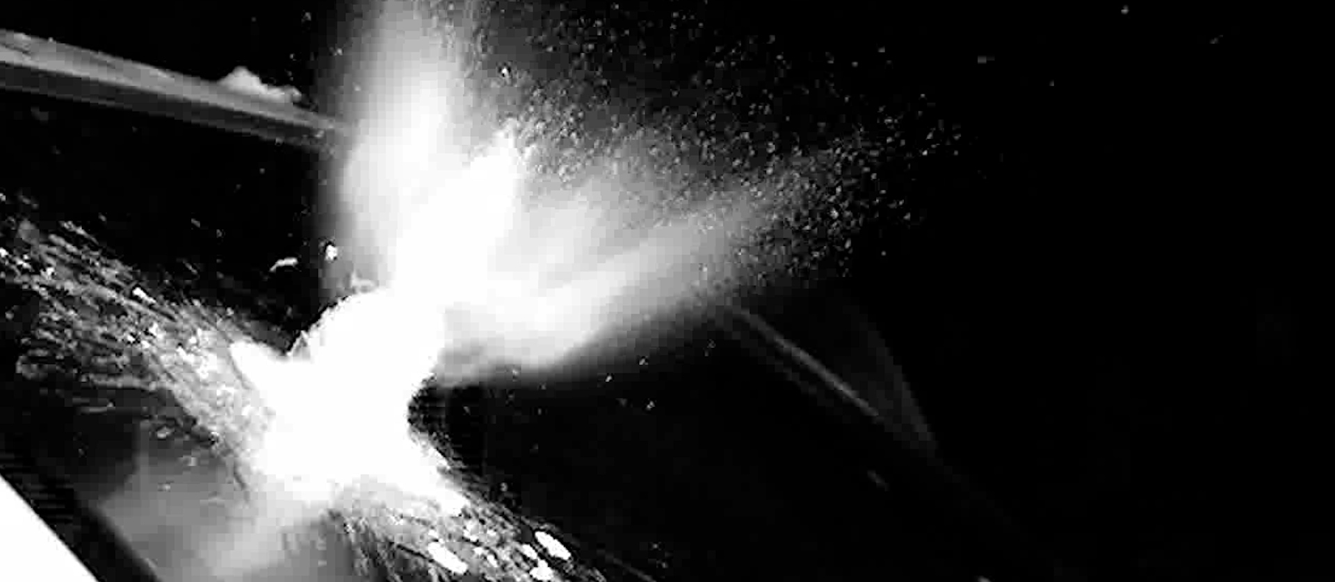 High-speed photo of a bullet impacting ballistic glass, demonstrating protection